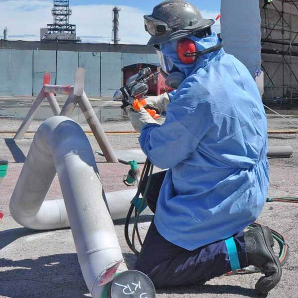 craftsman spray painting industrial pipe